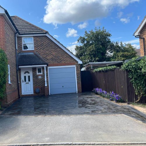 blue garage door - grey brick driveway