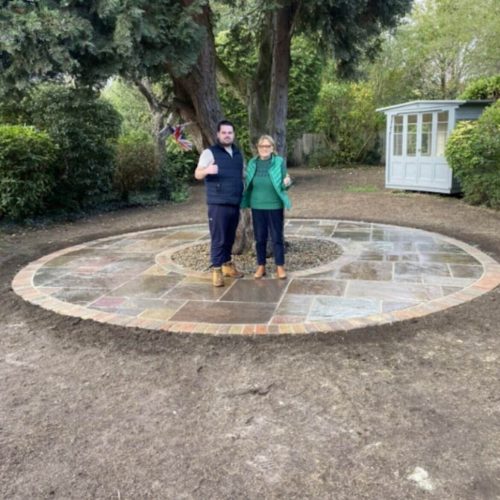 two people stood in a brick circle smiling